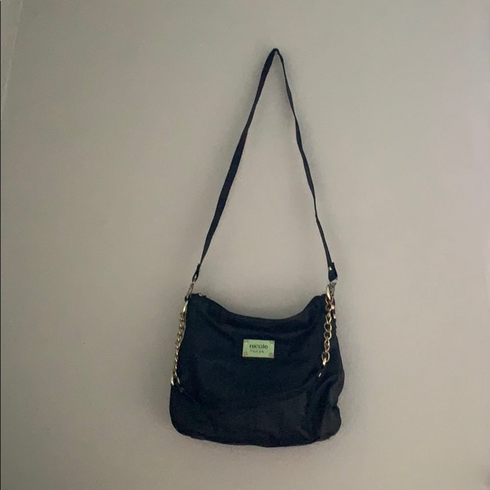 A black purse, with two straps.